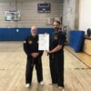 a black belt being awarded a dan certificate