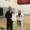 a black belt being awarded a black belt certificate